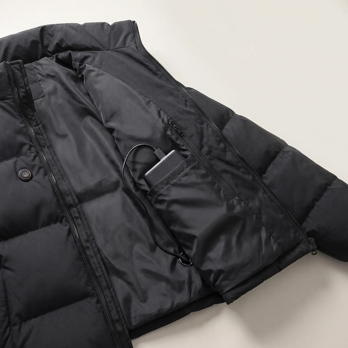 Geöffnete Jacke mit Powerbank in der Innentasche und Knopf auf der Brust